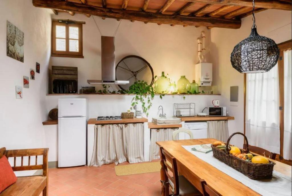 a kitchen with a table with a basket of fruit on it at Agriturismo le Bartaline in Pieve di Panzano