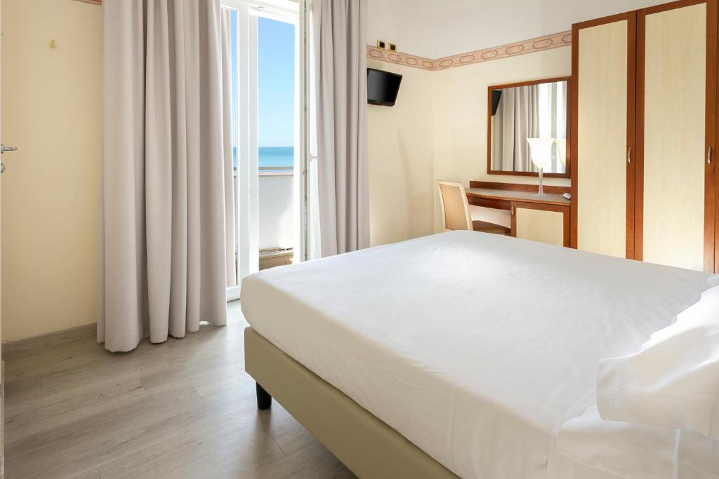 Postel nebo postele na pokoji v ubytování Hotel Bikini
