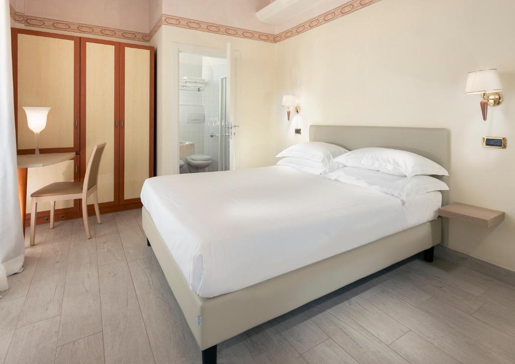 Postel nebo postele na pokoji v ubytování Hotel Bikini
