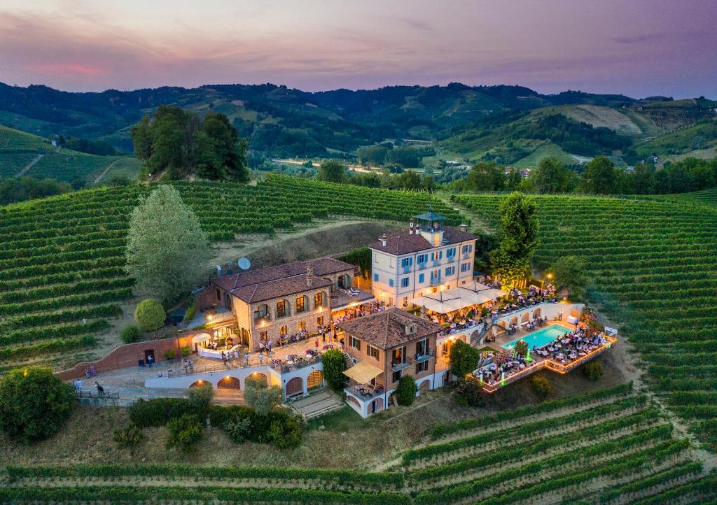 an aerial view of a mansion in a vineyard at Villa Tiboldi in Canale