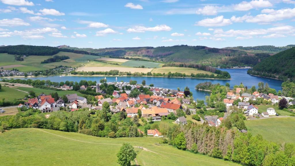 a small town in the hills next to a river at Sauerlandholiday in Diemelsee