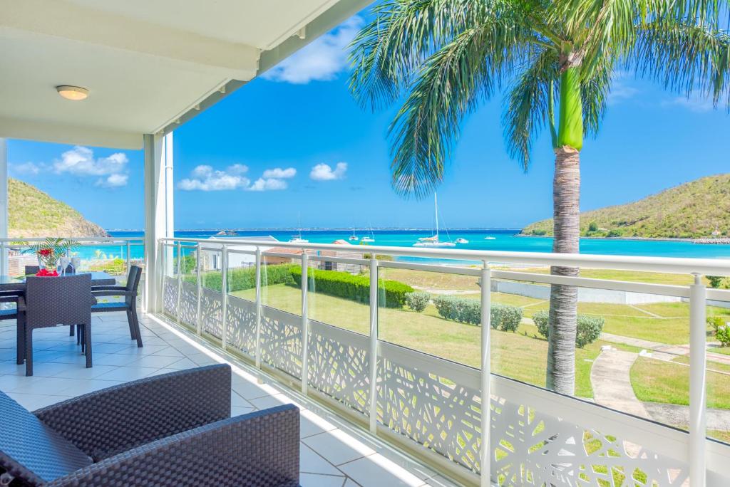 a balcony with a view of the ocean at Le Domaine Anse Marcel Beach Resort in Anse Marcel 