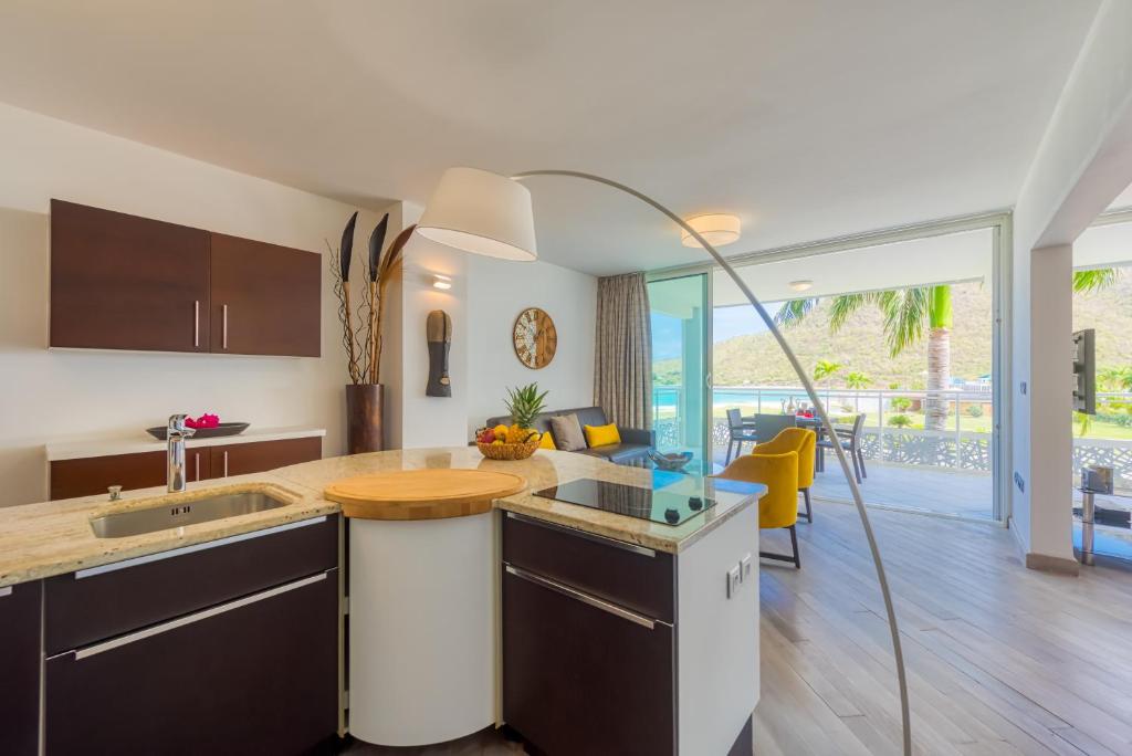 a kitchen with a sink and a counter top at Le Domaine Anse Marcel Beach Resort in Anse Marcel 