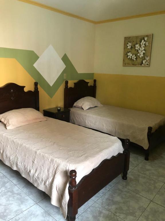 Postel nebo postele na pokoji v ubytování Residencial Alameda