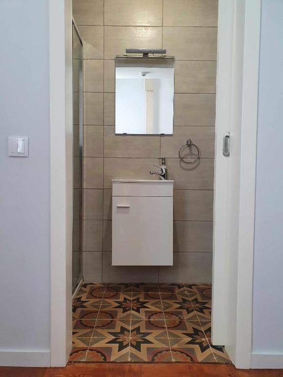 a bathroom with a sink and a mirror at Baron Faro - Guest House in Faro