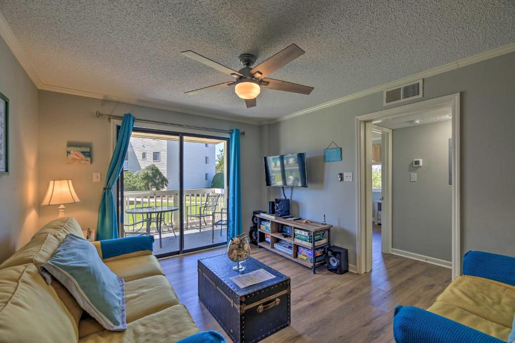 a living room with a couch and a ceiling fan at Emerald Isle Resort-Style Condo Walk to Beaches! in Emerald Isle