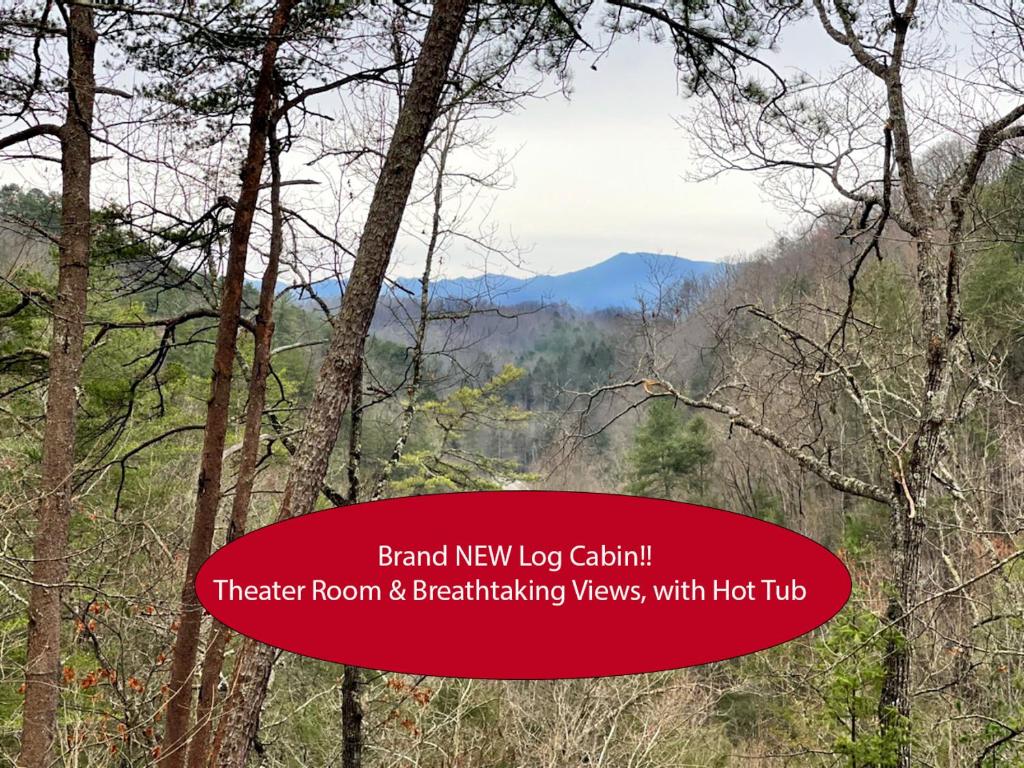 a sign that reads branch new log cabin theater room breakfast views with hot tub at Gatlinburg - Honeymoon Hideaway in Gatlinburg