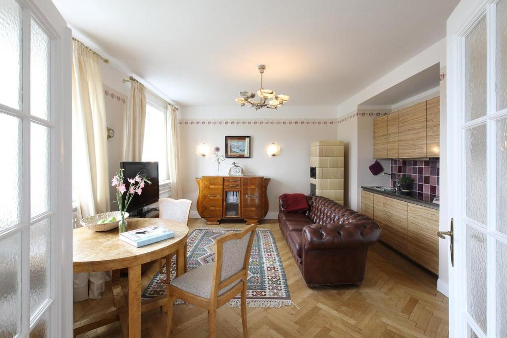a living room with a table and a leather couch at Ferienwohnung Art Deco in Hörnum