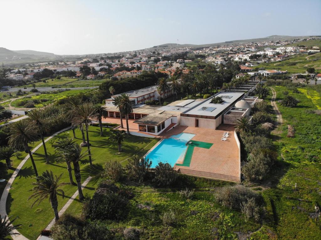 an aerial view of a house with a swimming pool at Hotel Porto Santo & Spa in Porto Santo
