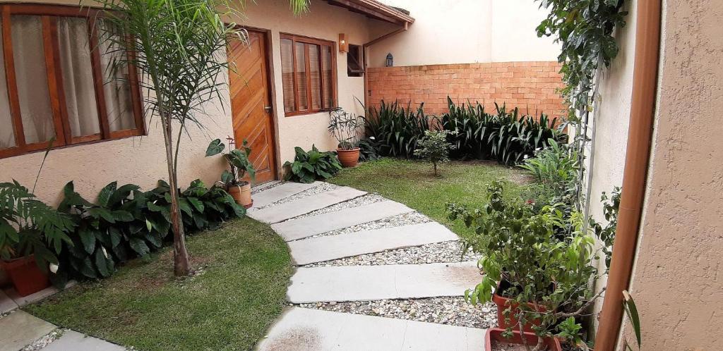un giardino con passerella di fronte a una casa di Pousada Mapuche a São José