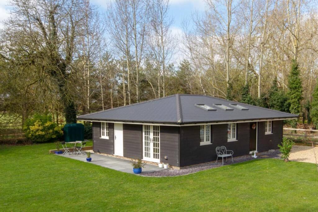 a tiny house with a pitched roof at Breckland Cottage - Secluded Country Getaway in Hockwold cum Wilton