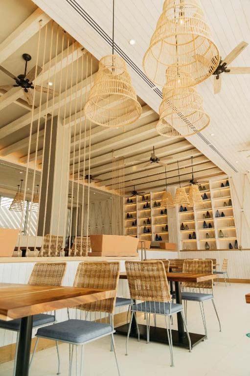 a dining room with tables and chairs and chandeliers at Emporio Cancun - Buy All Inclusive Option in Cancún