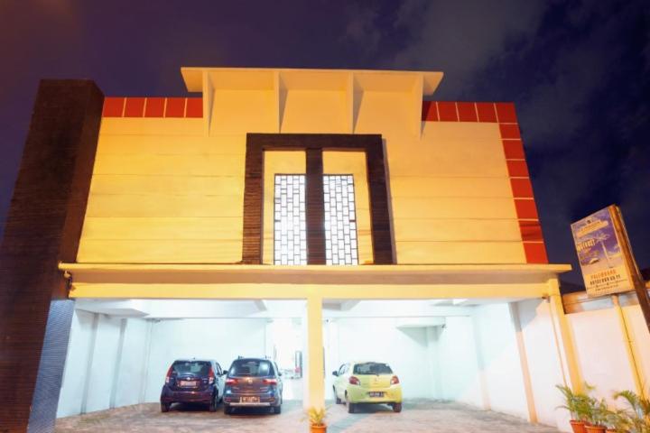 a large building with cars parked in a garage at DPARAGON DWIKORA in Palembang