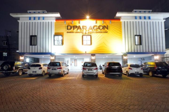 a car dealership with cars parked in a parking lot at DParagon Veteran in Banjarmasin