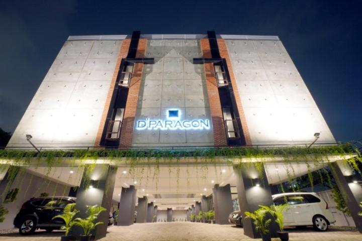 a car dealership with cars parked in front of a building at DPARAGON KEBON JERUK in Jakarta