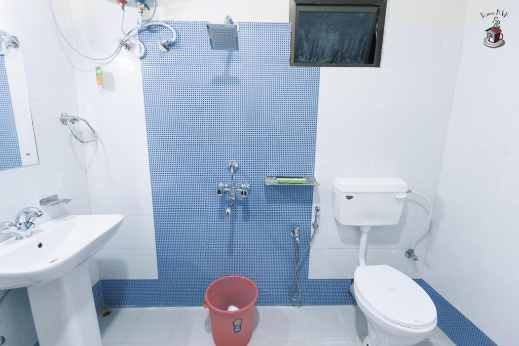 a bathroom with a shower and a toilet and a sink at Newest Deluxe BnB, Ranee BNB in Shillong