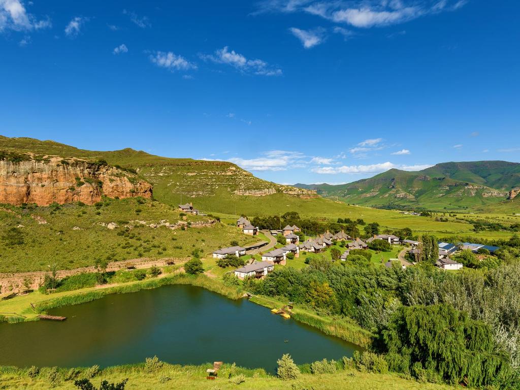 a scenic view of a lake and mountains at Kiara Lodge in Clarens