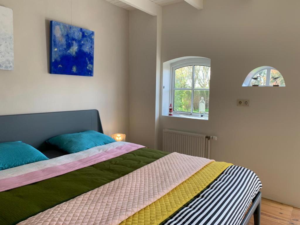 Postel nebo postele na pokoji v ubytování B&B De Vlasboerderij