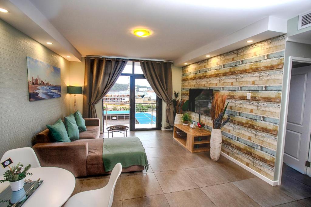 - un salon avec un canapé et une cheminée dans l'établissement Stay at the Point - Luxurious Lavish Looker, à Durban