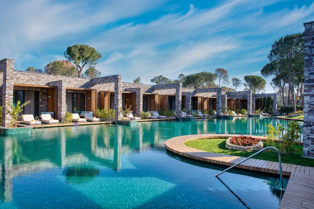 une image d'une maison avec une piscine dans l'établissement Kaya Palazzo Golf Resort, à Belek
