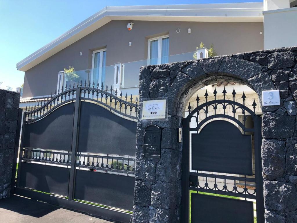 a black fence in front of a house at Casa Vacanze La Conca in San Giovanni la Punta