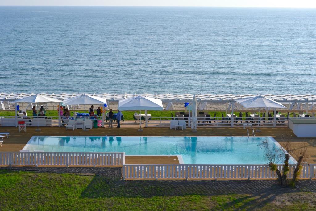 a swimming pool with a view of the ocean at Sunrise Accessible Resort in Battipaglia