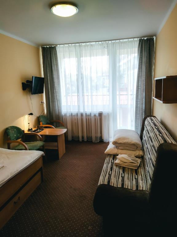 Postel nebo postele na pokoji v ubytování Ośrodek Wypoczynkowy Gwarek Ustronie Morskie
