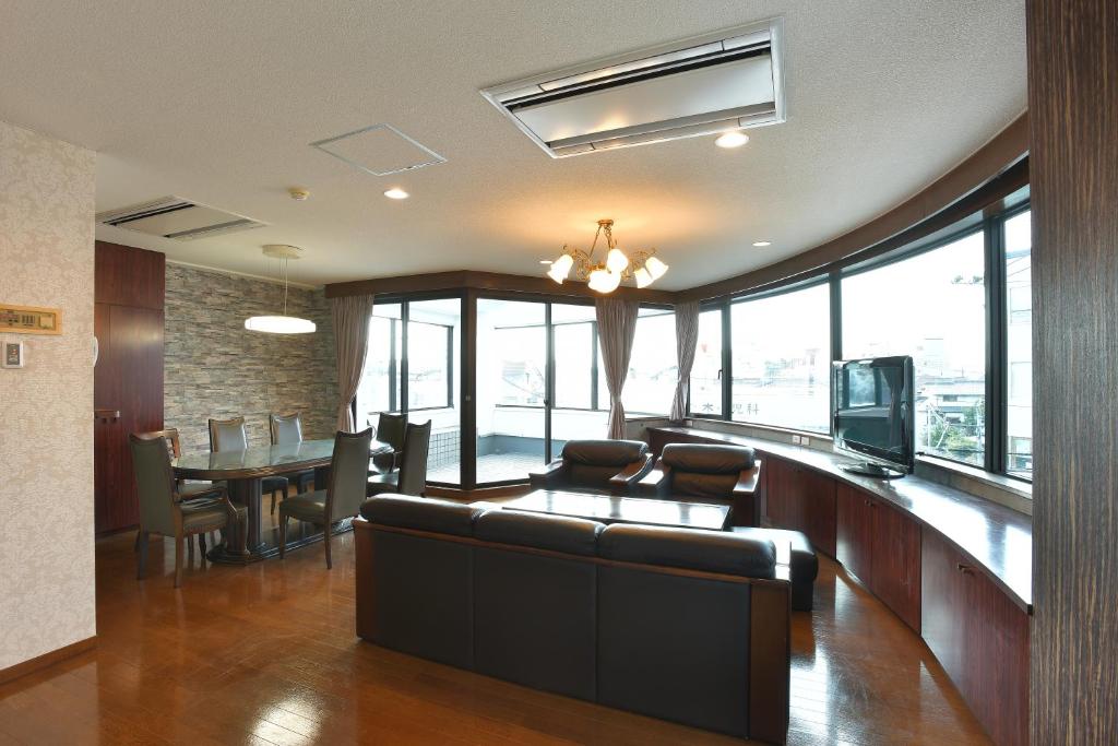 a living room with a couch and a television at lifeone club in Hiroshima