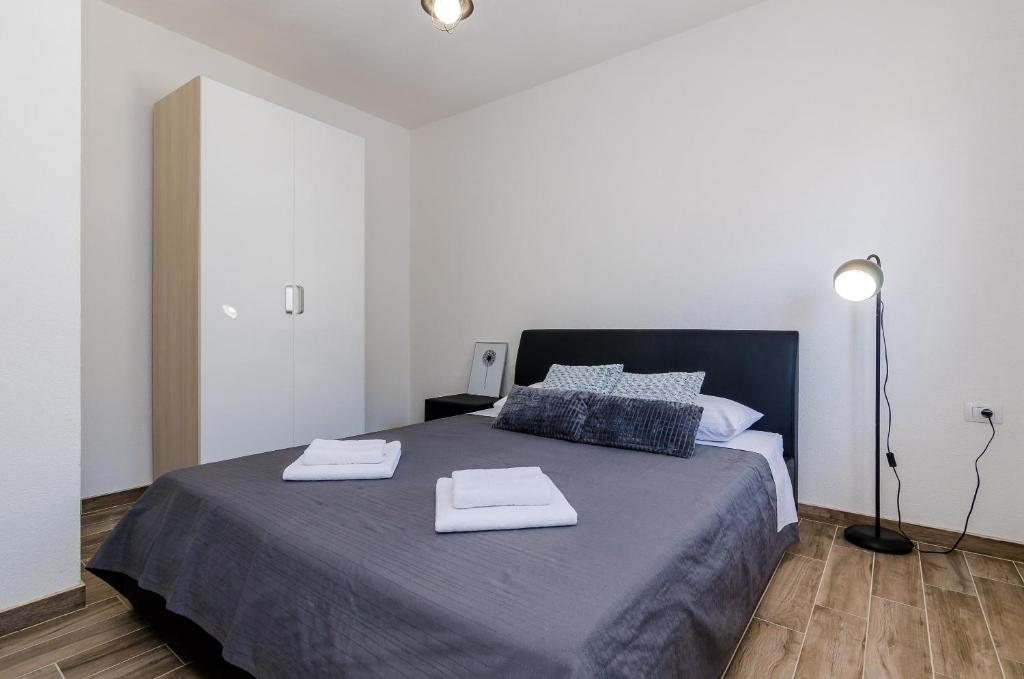 Postel nebo postele na pokoji v ubytování Apartments Life
