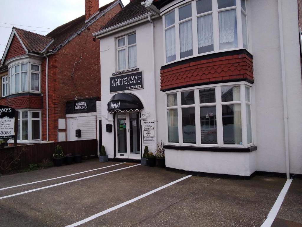 a parking lot in front of a building at Whiteways Guest House in Skegness