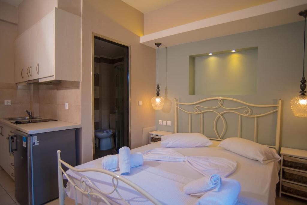 a bedroom with a bed with two white pillows at Studios Artemis in Lefkada