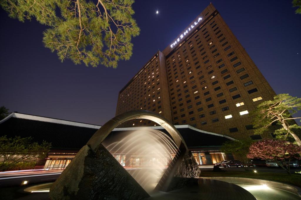 a water fountain in front of a building at night at The Shilla Seoul in Seoul