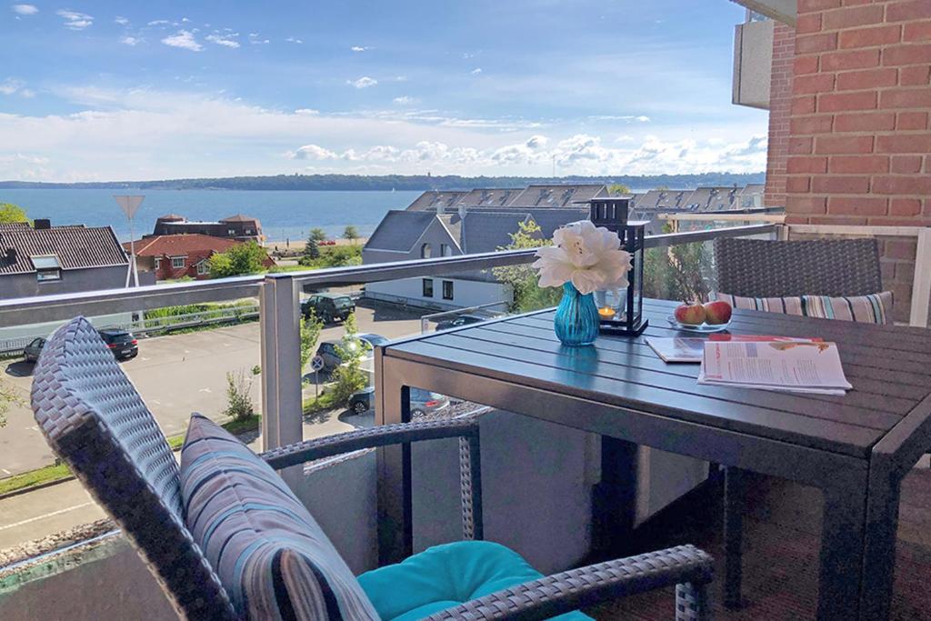 a table and chairs on a balcony with a view at fewo1846 - FoerdeNest - familienfreundliche Wohnung mit 2 Balkonen und Meerblick in Harrislee