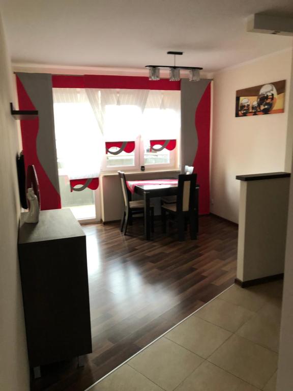 a kitchen and dining room with a table and chairs at Apartament Tuwima 8 in Ełk