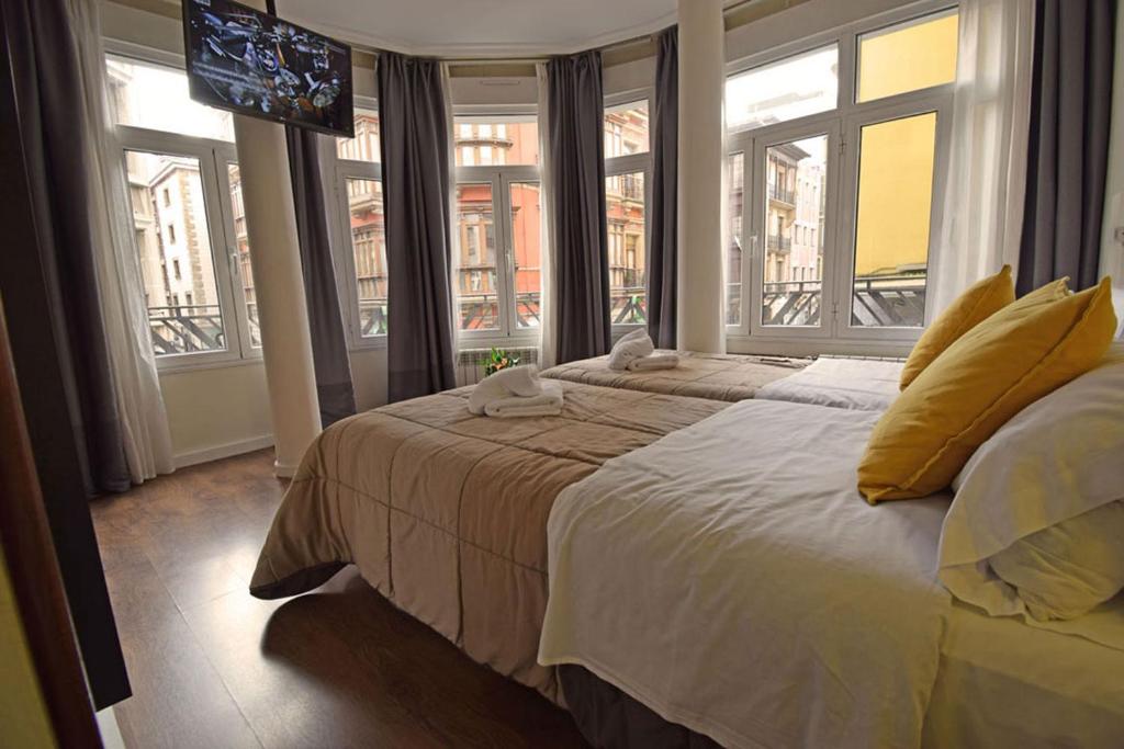 A bed or beds in a room at Hostel Gijón Centro