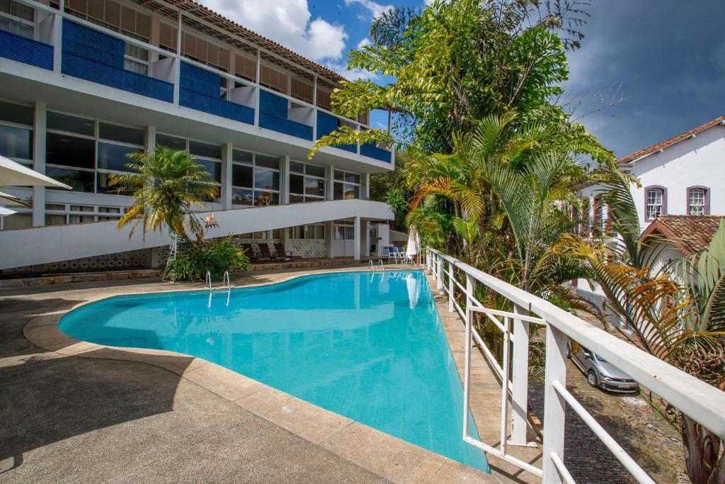 a swimming pool in front of a building at Grande Hotel de Ouro Preto - 80 ANOS in Ouro Preto