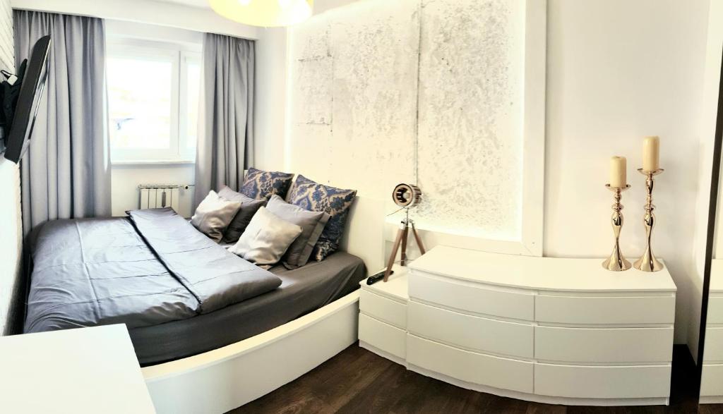 a bedroom with a bed and a bath tub at Apartament Modrzewskiego in Grudziądz