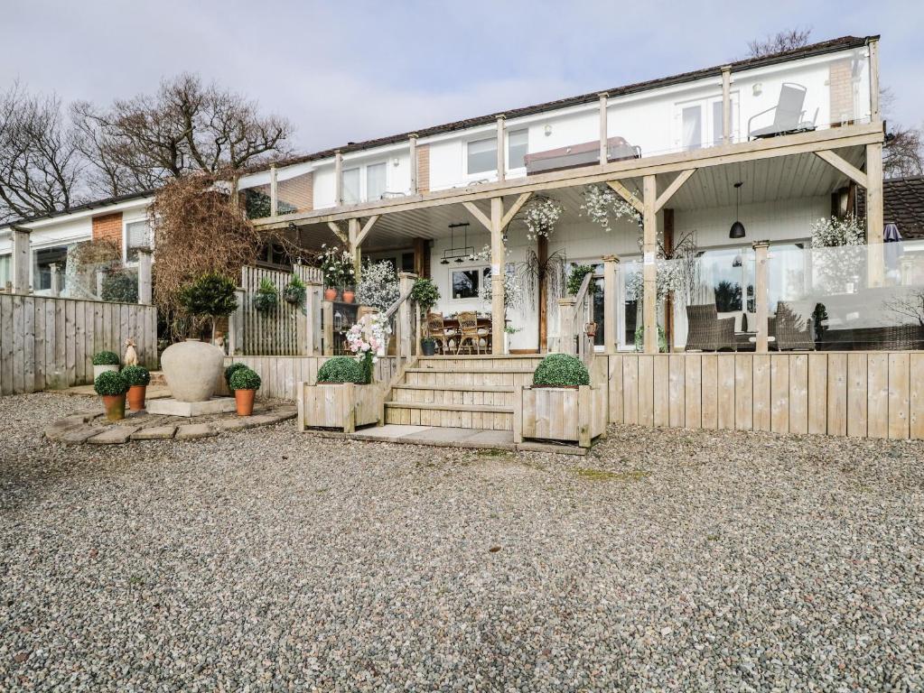 a house with a fence in front of it at High Rigg Garden Cottage in How