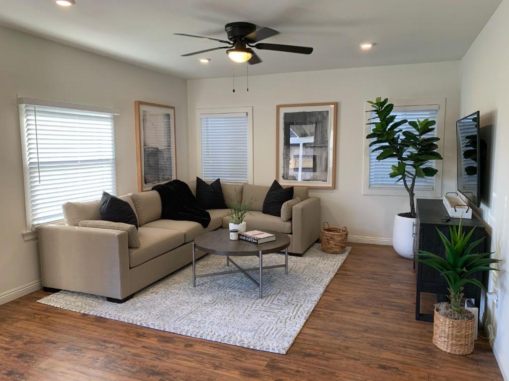 a living room with a couch and a table at Huntington Highlight - Pool, Patio, Close To Beach in Huntington Beach