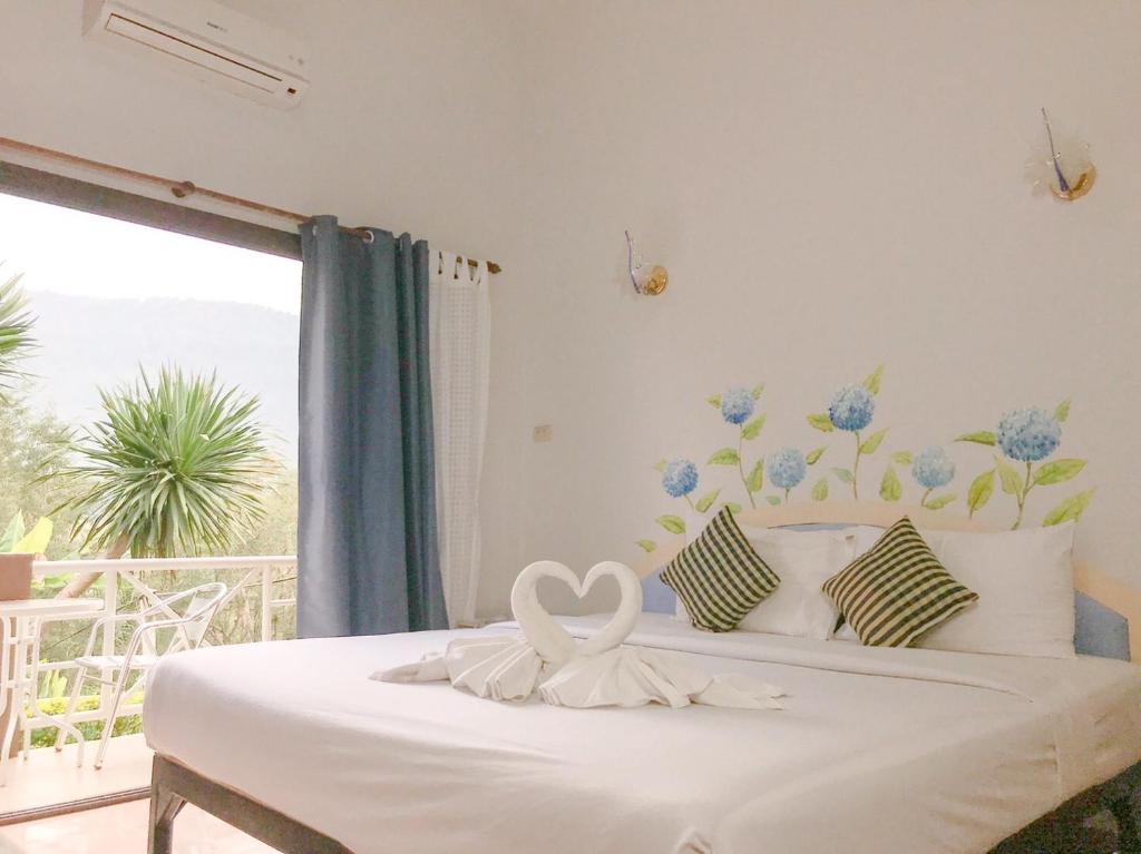 a bedroom with a bed with a heart decoration on it at Phurua Bussaba Resort & Spa ภูเรือบุษบารีสอร์ท แอนด์ สปา in Loei