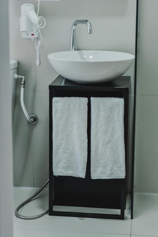 a bathroom with a sink and a white bowl at Atelier Boutique Hotel in Shkodër