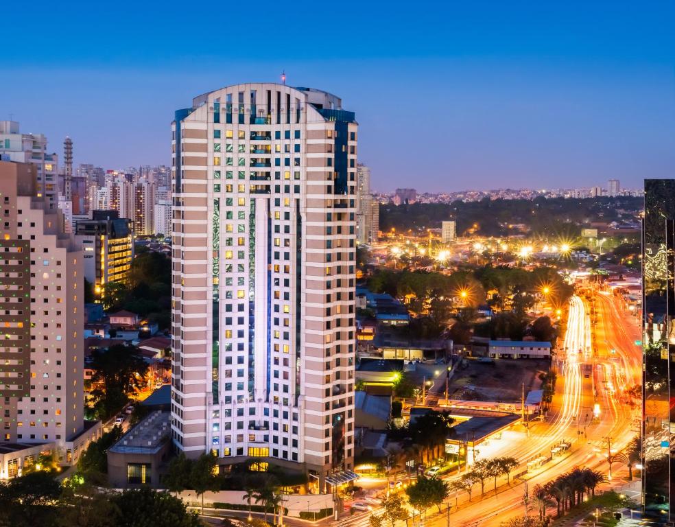 a tall white building in a city at night at Blue Tree Premium Morumbi in São Paulo