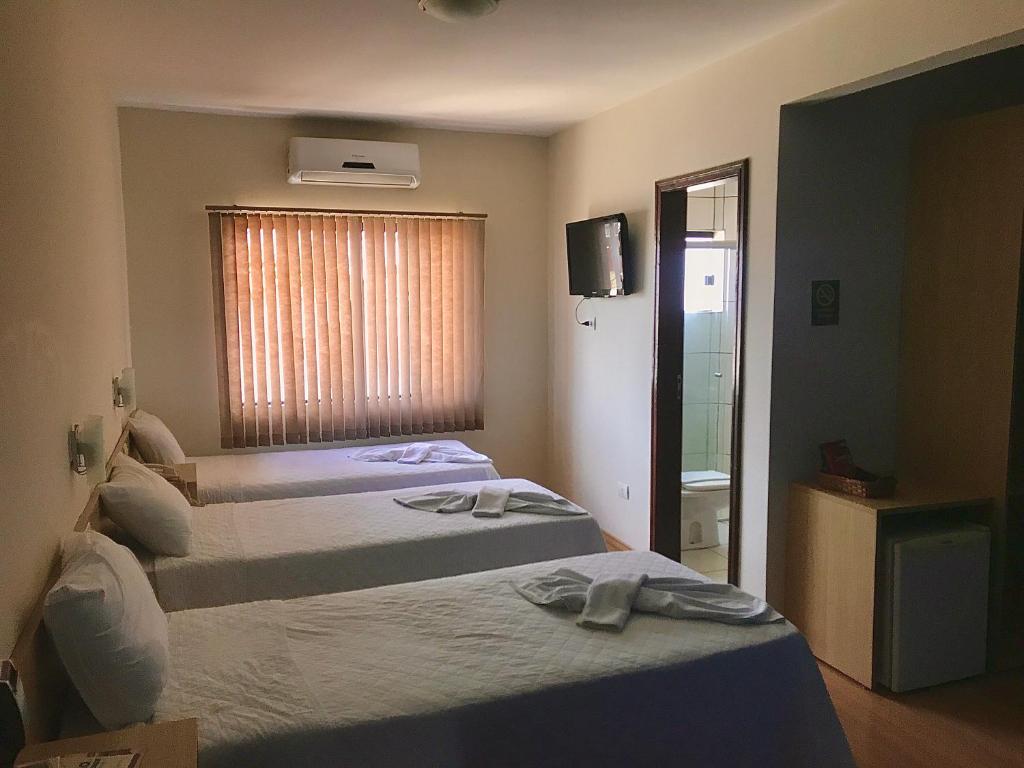 Postel nebo postele na pokoji v ubytování Hotel Dom Thomaz