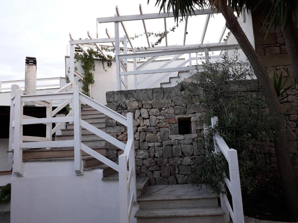 a set of stairs next to a stone wall at Masseria Artemisia in Torre San Giovanni Ugento