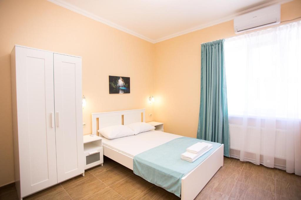 a small bedroom with a bed and a window at Guest house EdiRoz on Krepostnaya in Anapa