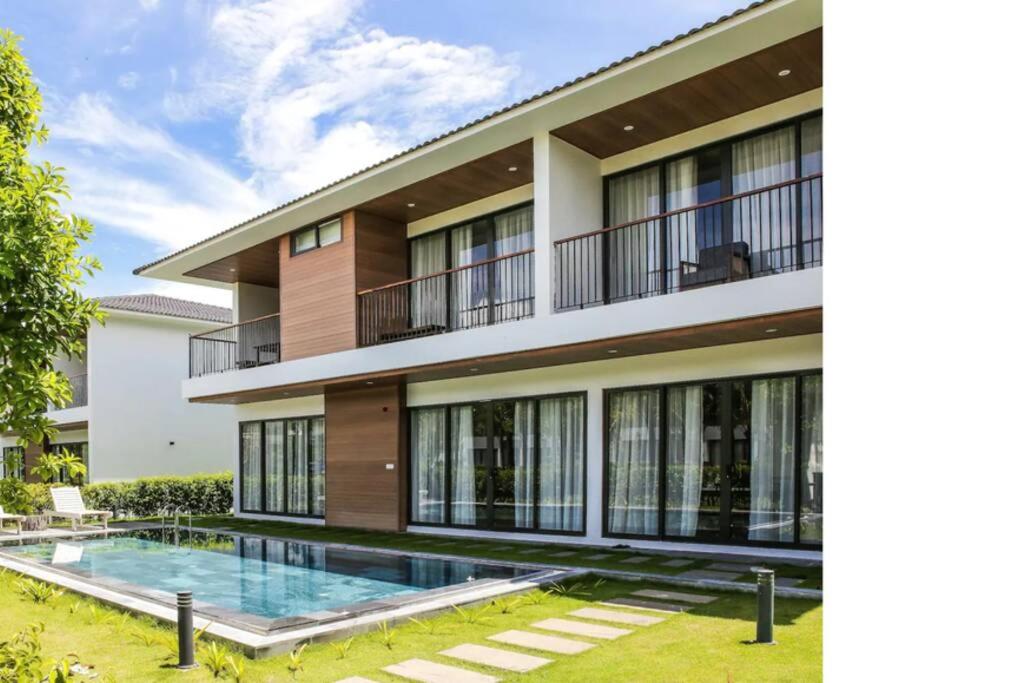 a house with a swimming pool in front of it at M Beach Luxury Villas Phu Quoc in Phu Quoc