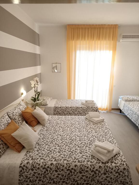 Postel nebo postele na pokoji v ubytování Hotel Cristoforo Colombo