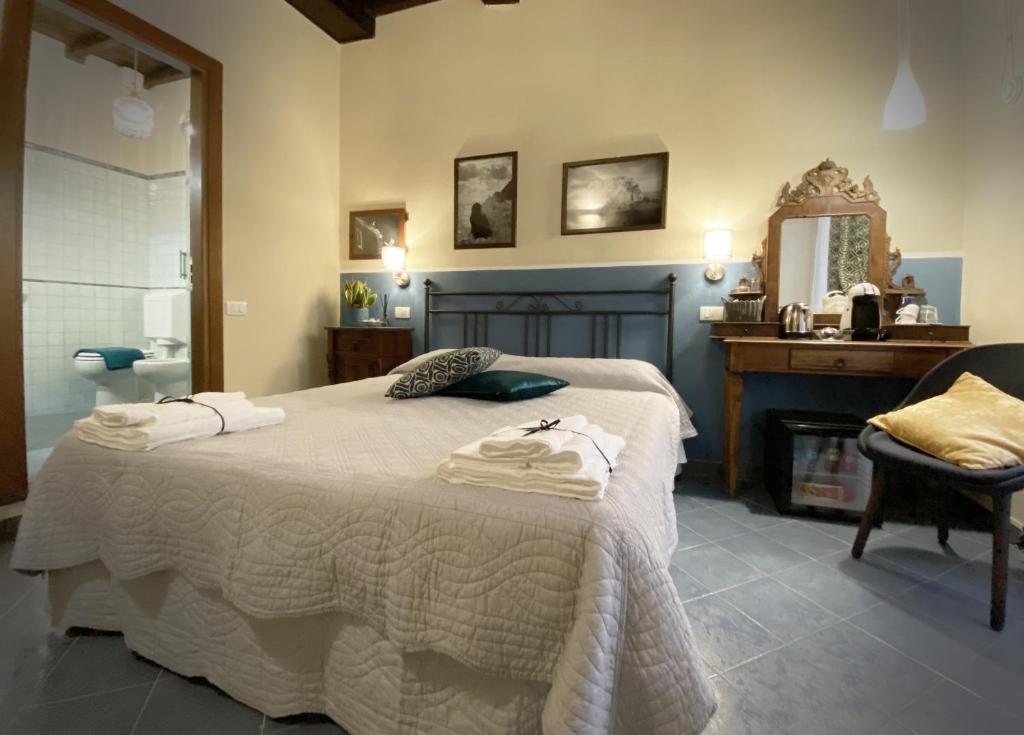 a bedroom with a bed with towels on it at Unico in Monterosso al Mare