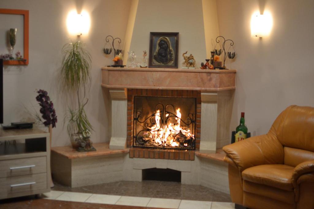 a living room with a fire in a fireplace at Home Sweet Home in Chişinău