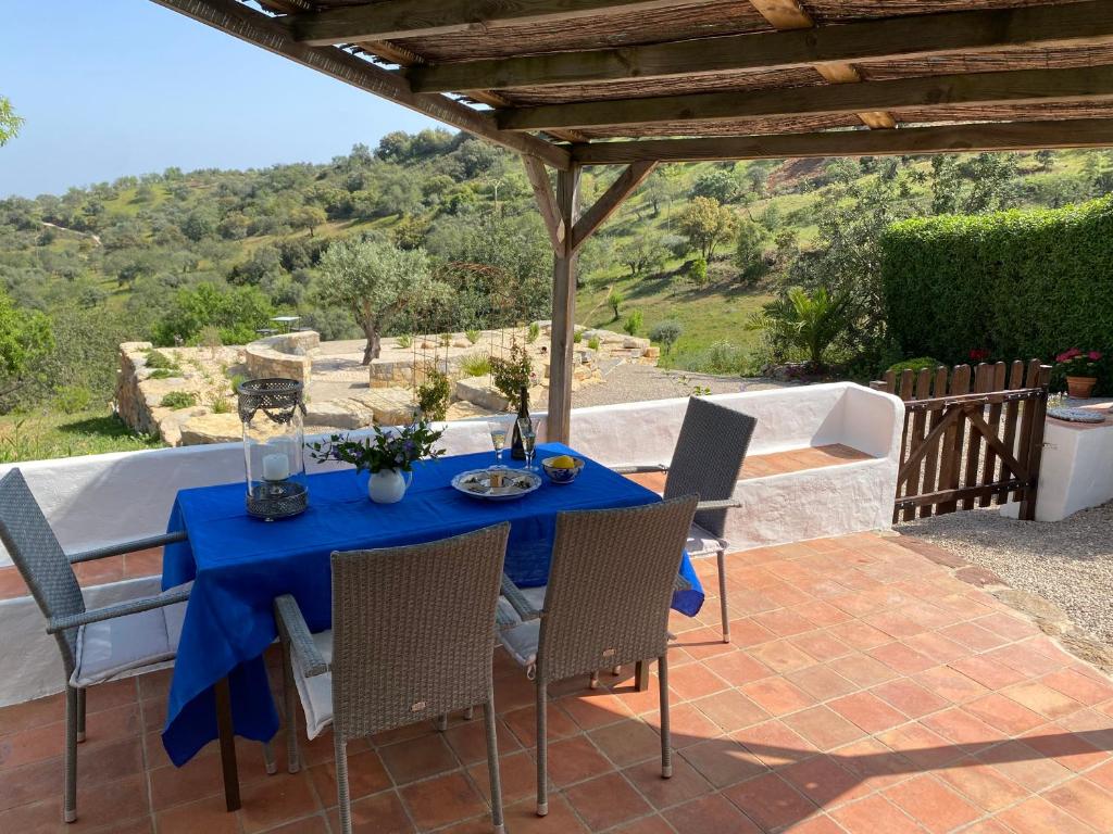 a table with a blue table cloth on a patio at Casa Olivia - Charming renovated farmhouse with panoramic views in Tavira